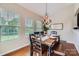 Bright dining room boasts a wooden table, stylish chandelier, and natural light from large windows at 5056 Crandon Rd, Fort Mill, SC 29707