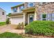 Inviting front porch with stone pillars and a well-maintained lawn and two-car garage at 5056 Crandon Rd, Fort Mill, SC 29707