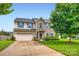 Charming two-story home boasts a well-manicured lawn, stone accents, and a two-car garage at 5056 Crandon Rd, Fort Mill, SC 29707