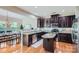 Modern kitchen featuring dark wood cabinets, granite countertops, and stainless steel appliances with hardwood flooring at 5056 Crandon Rd, Fort Mill, SC 29707