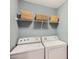 Laundry room with washer and dryer, a shelf with woven baskets and gray paint at 5056 Crandon Rd, Fort Mill, SC 29707