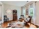 Cozy living room with hardwood floors, seating area, and natural light from windows at 5056 Crandon Rd, Fort Mill, SC 29707