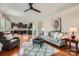 Open-concept living area flowing into a modern kitchen with hardwood flooring and a comfortable seating area at 5056 Crandon Rd, Fort Mill, SC 29707