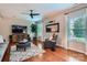 Comfortable living room with a ceiling fan, large windows, modern furnishings, and hardwood floors at 5056 Crandon Rd, Fort Mill, SC 29707