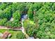Aerial shot outlining property lines, showcasing a home with a lawn, trees, and a long driveway at 5179 Poplar Glen Dr, Matthews, NC 28104