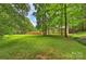 Lush, green backyard, fully fenced with trees and lots of open space for fun and games at 5179 Poplar Glen Dr, Matthews, NC 28104