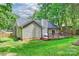 Spacious backyard featuring a charming back deck, lush green lawn, and mature trees for added privacy at 5179 Poplar Glen Dr, Matthews, NC 28104