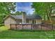Backyard deck featuring a grill, an outdoor dining table, and lounge chairs at 5179 Poplar Glen Dr, Matthews, NC 28104