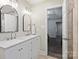 Bathroom featuring a double sink vanity with modern fixtures and a shower at 5179 Poplar Glen Dr, Matthews, NC 28104