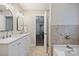 Bathroom featuring a double sink vanity with modern fixtures and a bathtub at 5179 Poplar Glen Dr, Matthews, NC 28104