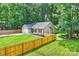 Inviting home featuring a manicured lawn, wood fence, and an attached two car garage at 5179 Poplar Glen Dr, Matthews, NC 28104