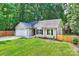 Well-maintained house with an attached garage, lush lawn, and colorful landscaping at 5179 Poplar Glen Dr, Matthews, NC 28104