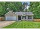 Charming single-story home with a well-manicured lawn, attached garage, and beautiful landscaping at 5179 Poplar Glen Dr, Matthews, NC 28104