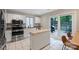 Bright kitchen with stainless steel appliances and a door leading to the outdoor deck and dining area at 5179 Poplar Glen Dr, Matthews, NC 28104