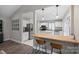 Bright kitchen with stainless steel appliances, wooden breakfast bar with chairs and tile flooring at 5179 Poplar Glen Dr, Matthews, NC 28104
