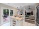 Bright kitchen with stainless steel appliances, access to the deck, and an open floorplan with seamless flow to the living room at 5179 Poplar Glen Dr, Matthews, NC 28104