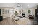 Bright living room featuring vaulted ceilings, fireplace, ceiling fan, and an open floorplan with seamless flow to other living spaces at 5179 Poplar Glen Dr, Matthews, NC 28104
