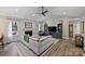 Inviting living room with a fireplace, vaulted ceiling, ceiling fan, and ample seating at 5179 Poplar Glen Dr, Matthews, NC 28104