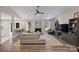 Bright living room featuring vaulted ceilings, fireplace, ceiling fan, and an open floorplan with seamless flow to other living spaces at 5179 Poplar Glen Dr, Matthews, NC 28104
