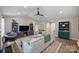 Bright living room featuring vaulted ceilings, ceiling fan, stylish furniture, and an open floorplan with seamless flow to other rooms at 5179 Poplar Glen Dr, Matthews, NC 28104