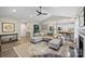 Bright living room featuring vaulted ceilings, fireplace, ceiling fan, and an open floorplan with seamless flow to other living spaces at 5179 Poplar Glen Dr, Matthews, NC 28104