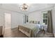 Comfortable main bedroom with a decorative ceiling light fixture and plenty of natural light at 5179 Poplar Glen Dr, Matthews, NC 28104