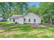The backyard showcases a well-maintained lawn, mature trees, and a classic exterior elevation at 5817 Rocky Mount Ct, Charlotte, NC 28214