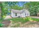 The backyard showcases a well-maintained lawn, mature trees, and a classic exterior elevation at 5817 Rocky Mount Ct, Charlotte, NC 28214