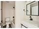 This renovated bathroom has a modern vanity, a black framed mirror, and a shower with a tub at 5817 Rocky Mount Ct, Charlotte, NC 28214