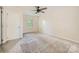 Spacious bedroom featuring a ceiling fan and a window providing natural light at 5817 Rocky Mount Ct, Charlotte, NC 28214