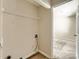 A practical closet space is equipped with shelving and ready for a washer and dryer hook up at 5817 Rocky Mount Ct, Charlotte, NC 28214