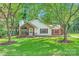 Charming home with a brick and siding exterior, manicured lawn, and mature trees in a serene setting at 5817 Rocky Mount Ct, Charlotte, NC 28214