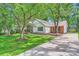 Charming home with a well-manicured front lawn, mature trees and tasteful landscaping features at 5817 Rocky Mount Ct, Charlotte, NC 28214