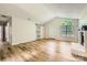 Spacious living room with hardwood floors, vaulted ceilings, modern lighting, and a sliding barn door feature at 5817 Rocky Mount Ct, Charlotte, NC 28214