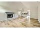 Spacious living room with hardwood floors, fireplace, and a seamless flow into the adjacent kitchen area at 5817 Rocky Mount Ct, Charlotte, NC 28214