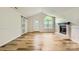 Inviting living room with vaulted ceiling, fireplace, ample natural light, and hardwood flooring at 5817 Rocky Mount Ct, Charlotte, NC 28214