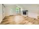 Living room with fireplace, hardwood floors, ample natural light, and a sliding barn door feature at 5817 Rocky Mount Ct, Charlotte, NC 28214