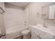 Bright bathroom features a tub-shower combo, a white vanity, and modern fixtures at 601 N Johnson St, Monroe, NC 28112