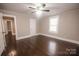 Cozy bedroom with gleaming hardwood floors, neutral walls, and a modern ceiling fan at 601 N Johnson St, Monroe, NC 28112