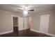 Large bedroom with hardwood floors and ceiling fan features adjacent closets and entryways at 601 N Johnson St, Monroe, NC 28112