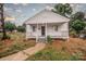 Charming home with a quaint front porch, freshly painted white exterior, and inviting curb appeal at 601 N Johnson St, Monroe, NC 28112