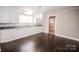 Bright kitchen features white cabinets, updated countertop, and hardwood floors with ample space for dining at 601 N Johnson St, Monroe, NC 28112