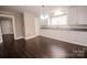 Spacious kitchen area with white cabinets, stone countertops, and dark hardwood flooring for a clean aesthetic at 601 N Johnson St, Monroe, NC 28112