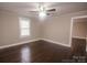 Bright living room with beautiful dark wood floors, neutral walls, ceiling fan, and ample natural light at 601 N Johnson St, Monroe, NC 28112