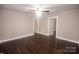 Spacious living room features hardwood floors, neutral wall paint, and is illuminated by a modern ceiling fan at 601 N Johnson St, Monroe, NC 28112