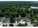Captured from an aerial perspective, the neighborhood features a variety of homes amidst a backdrop of verdant trees at 612 Ideal Way, Charlotte, NC 28203