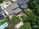 Aerial view showcases a lush backyard with a basketball court, pristine pool, and inviting covered deck at 612 Ideal Way, Charlotte, NC 28203