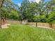 Large backyard featuring a basketball court, shed, and a well-maintained lawn at 612 Ideal Way, Charlotte, NC 28203