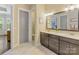 Bathroom with a double sink vanity and a gray door leading to a separate toilet room at 612 Ideal Way, Charlotte, NC 28203