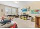 bedroom with neutral walls, carpet, shuttered windows, and colorful decorations on the walls at 612 Ideal Way, Charlotte, NC 28203